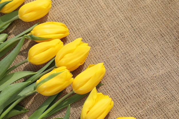 textile background with yellow tulips and copy space