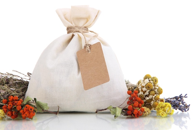 Photo textile sachet pouch with dried flowers herbs and berries isolated on white