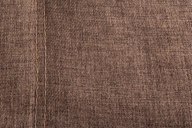 Textile surface with stitching Textured brown background