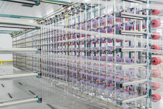 Textile yarn on the warping machine. machinery and equipment in a textile factory