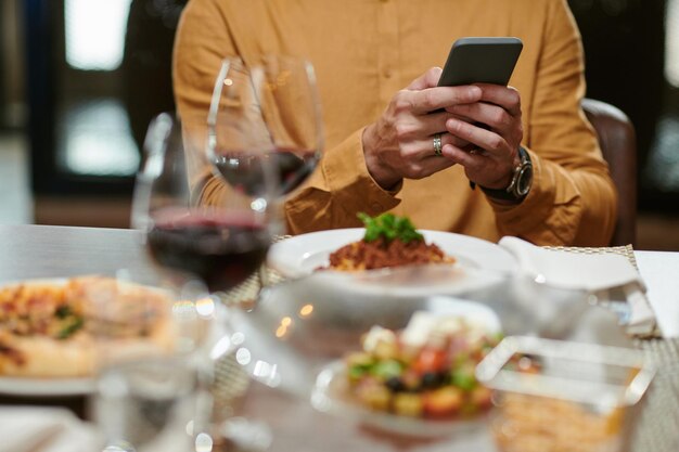 Texting Man Eating in Restaurant