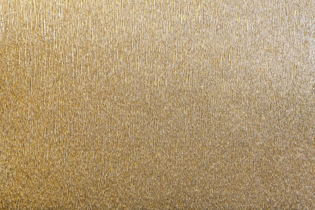 Textural of golden background of wavy corrugated paper, closeup.