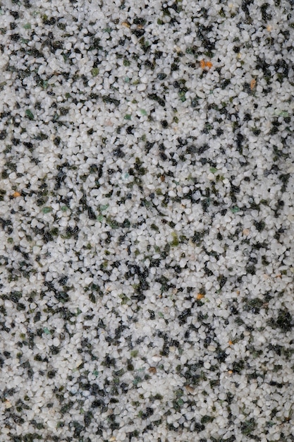 textural plaster of the house wall colored granite chips background