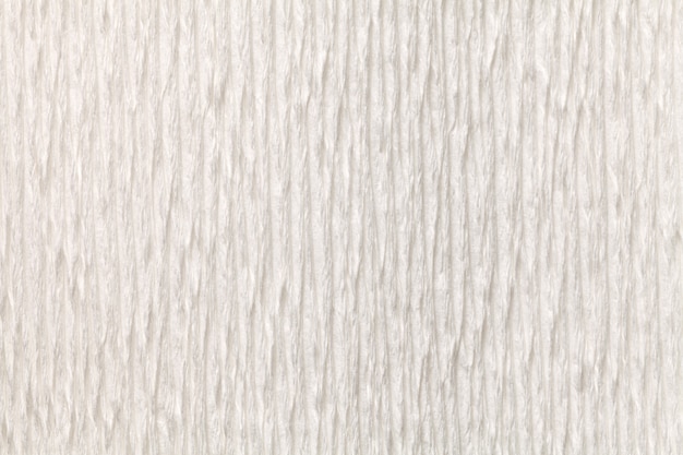 Textural white background of wavy corrugated paper, close-up.