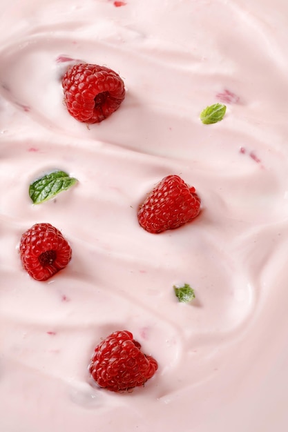 Texture background of Pink Yogurt with raspberries Curl of Yogurt Pink nature yogurt sour cream