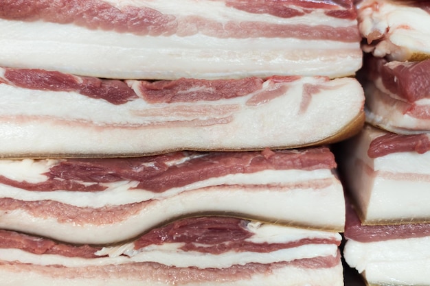 Texture of bacon close-up lying beside and one above the other