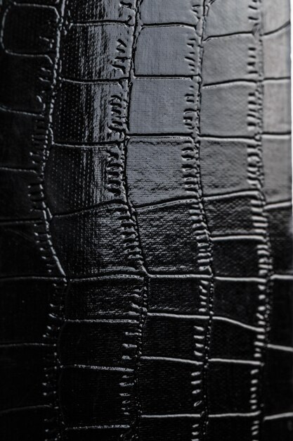 Texture of black crocodile skin in the background in full screen