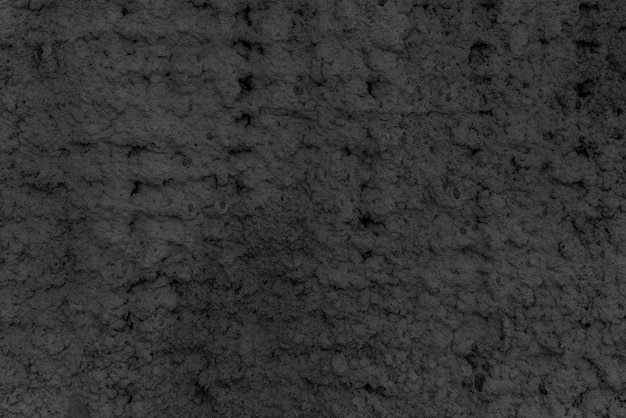 Texture of black plaster. Rough wall of the building.