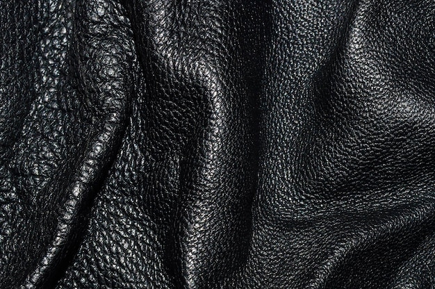 Texture of black rough leather closeup