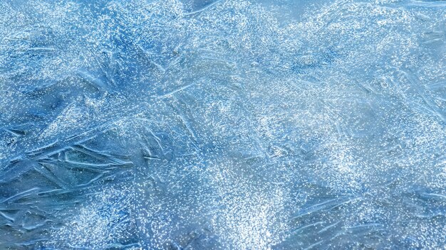 Texture of blue ice on the river in sunny weather