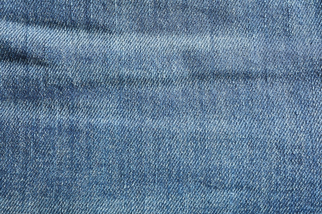 Texture of blue jeans as background, space for text