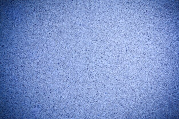 Texture blue recycled compressed wood chippings board background.