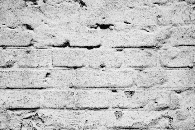 テクスチャ、レンガ、壁の背景。傷やひび割れのあるレンガの質感