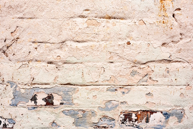 Texture of a brick wall with cracks and scratches which can be used as a background