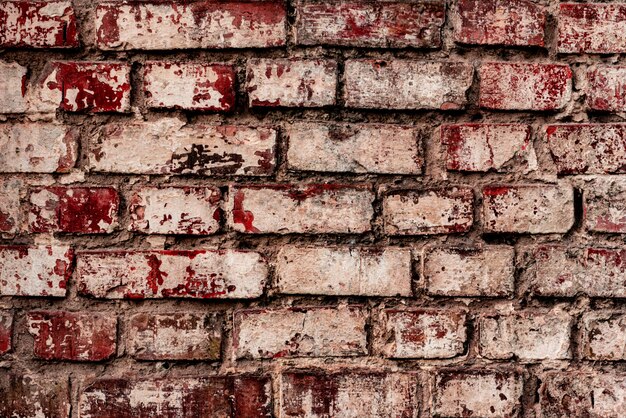 Texture of a brick wall with cracks and scratches which can be used as a background