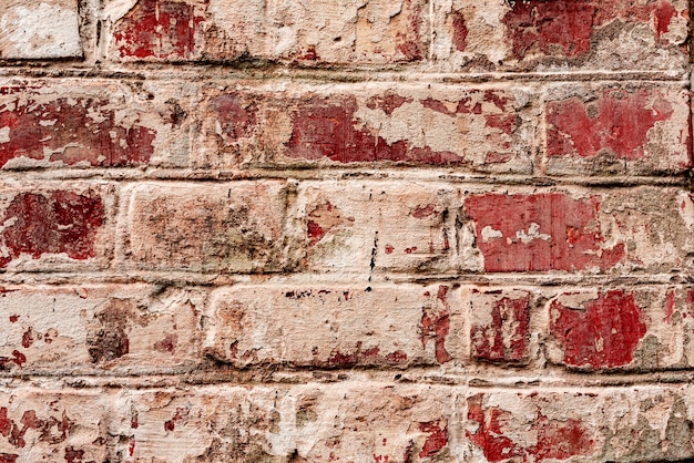 Texture of a brick wall with cracks and scratches which can be used as a background