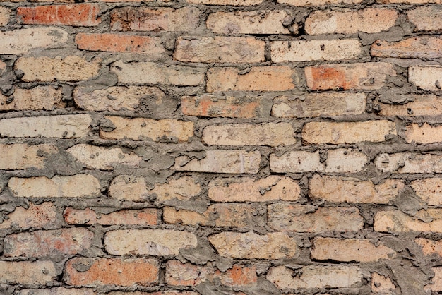 Texture of a brick wall with cracks and scratches which can be used as a background