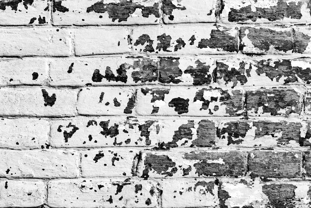 Texture of a brick wall with cracks and scratches which can be used as a background