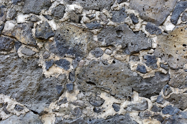 Texture of bricks made of stone Stone wall from colonial times