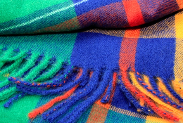 Texture of a bright multicolor scarf with fringe