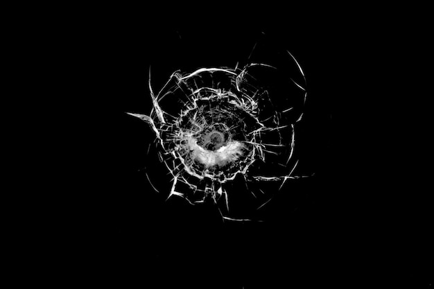 Texture of broken glass Hole from a ball on a black background