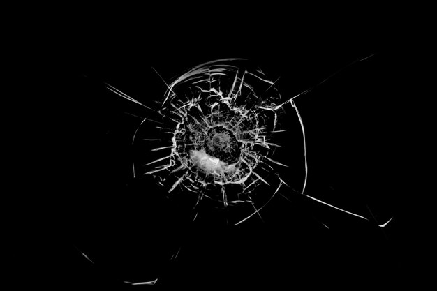 Texture of broken glass Hole from a ball on a black background