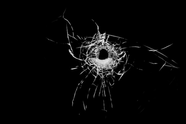 Texture of broken glass Hole from a ball on a black background