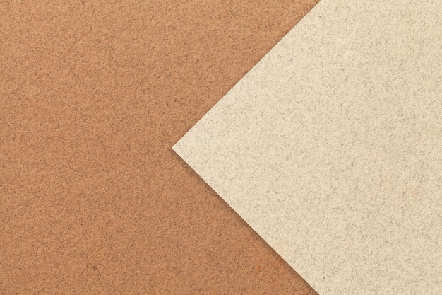 Texture of brown paper background half two colors with light beige arrow Structure of umber craft cardboard