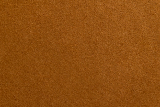 Photo texture of brown suede or velour cloth closeup natural or artificial sewing material fabric as background for design