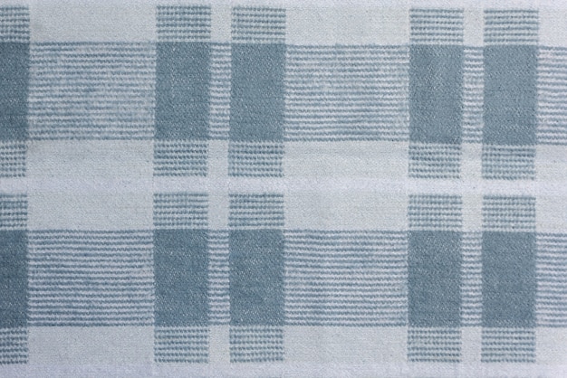 Texture of the checkered fabric is pale blue