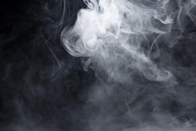 Texture of cigarette white smoke on a black wall