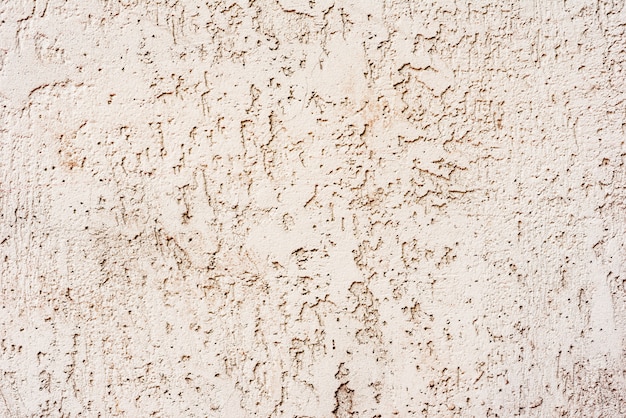 Foto texture di un muro di cemento con crepe e graffi