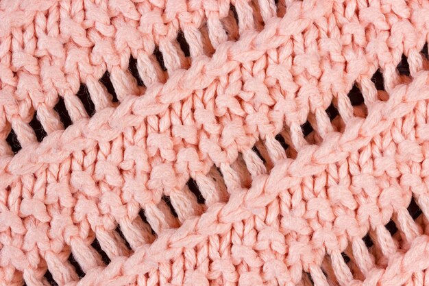 Texture of coral knitted woolen fabric close up