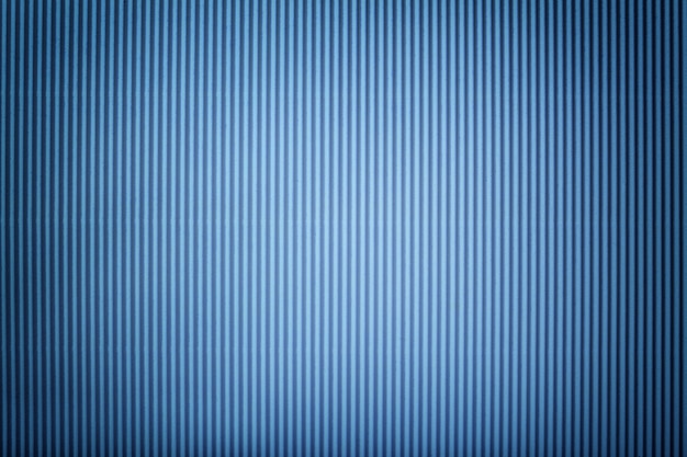 Texture of corrugated blue paper with vignette, macro.