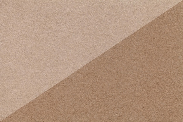 Photo texture of craft beige and brown paper background half two colors macro structure of vintage dense kraft cardboard