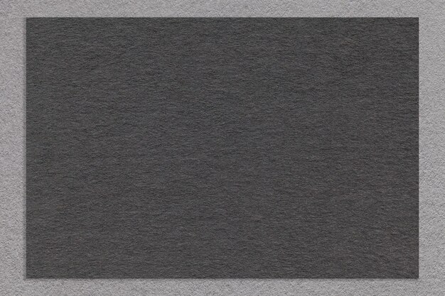 Texture of craft black color paper background with gray border macro Structure of vintage dense kraft grey cardboard