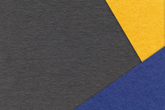 Texture of craft black color paper background with yellow and navy blue border Vintage abstract cardboard