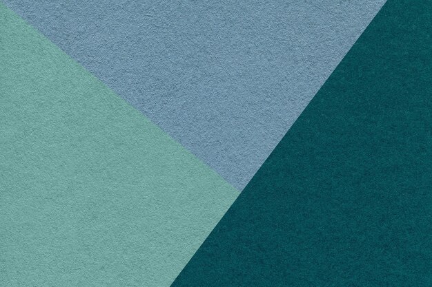 Texture of craft cyan emerald and blue shade color paper background macro Vintage teal abstract cardboard