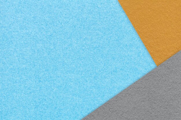 Texture of craft light blue color paper background with orange and gray border Vintage abstract cerulean cardboard Presentation template and mockup with copy space Felt backdrop closeup