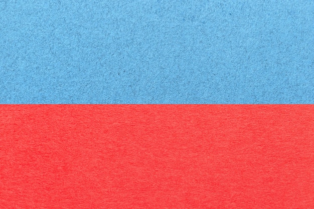 Texture of craft light blue and red paper background half two colors macro Structure of vintage craft cardboard