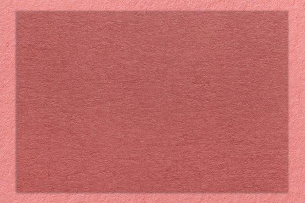 Texture of craft maroon color paper background with pink border macro Structure of vintage dense kraft rose cardboard
