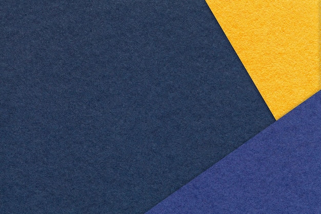 Texture of craft navy blue color paper background with denim and yellow border Vintage abstract cardboard