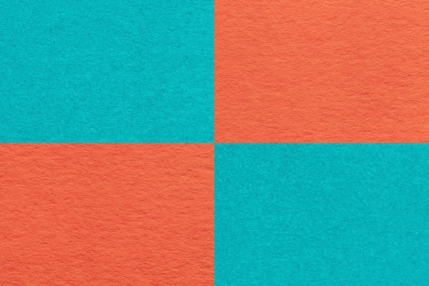 Texture of craft orange and turquoise paper background with cells pattern macro Structure of vintage cyan cardboard