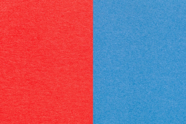 Texture of craft red and blue paper background half two colors macro Structure of vintage dense craft cardboard Felt backdrop closeup