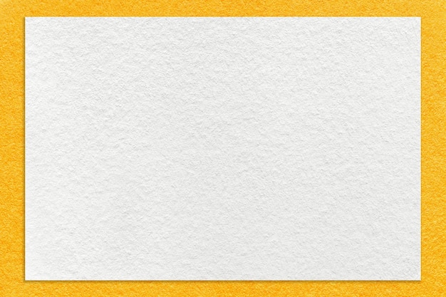 Texture of craft white color paper background with yellow border macro Vintage dense kraft orange cardboard