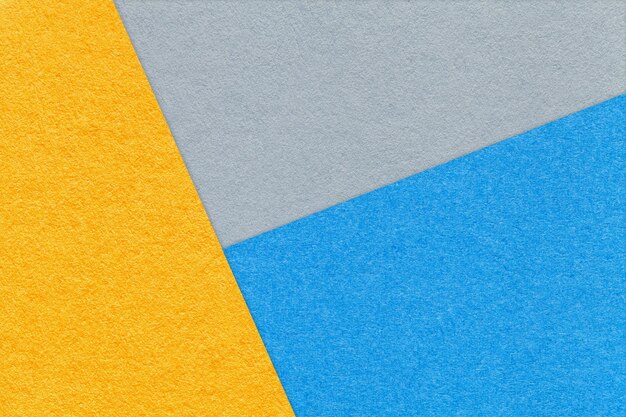 Texture of craft yellow blue and gray shade color paper background macro Structure of vintage abstract cardboard