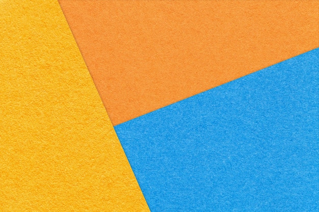 Texture of craft yellow blue and orange shade color paper background Structure of vintage abstract cardboard