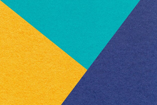 Texture of craft yellow cyan and navy blue shade color paper background macro Structure of vintage abstract cardboard