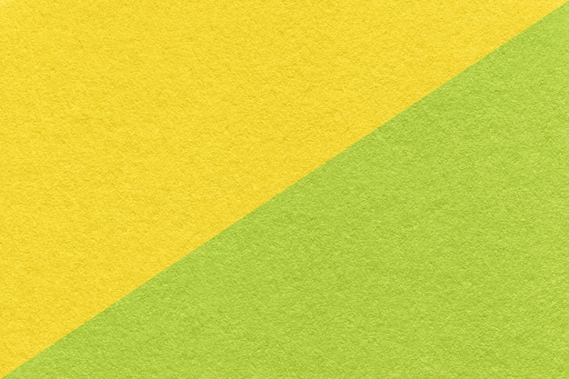 Texture of craft yellow and green paper background half two colors macro Structure of vintage cardboard