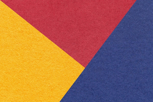 Texture of craft yellow red and navy blue shade color paper background macro Structure of vintage abstract cardboard